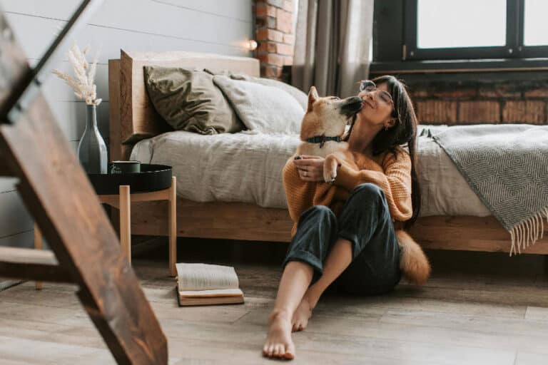 An image of a dog and a woman cuddling, after successful Miami dog training