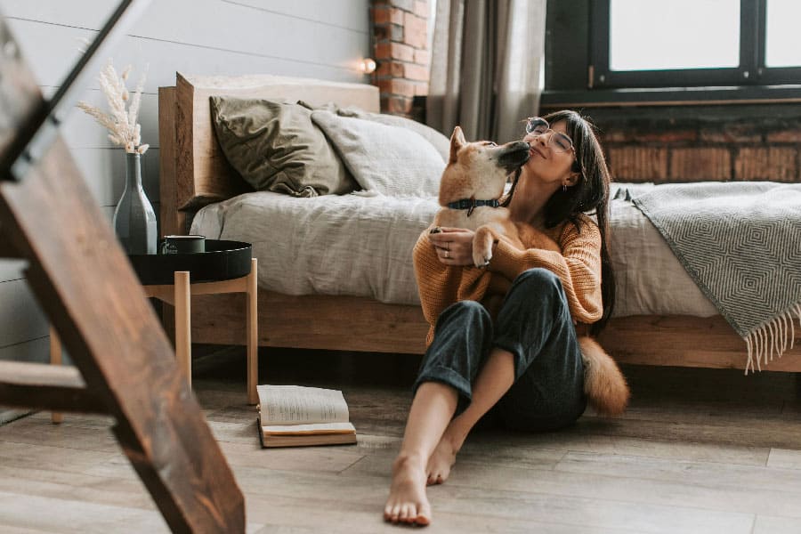 An image of a dog and a woman cuddling, after successful Miami dog training