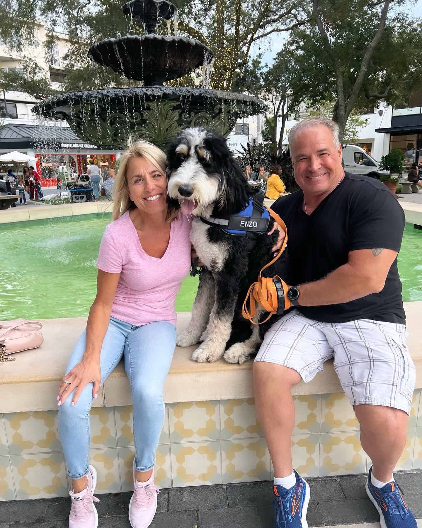 A happy couple with their dog after purchasing dog training in Miami, FL